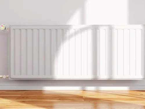 A horizontal white panel radiator mounted on a white wall with a control valve on the top left.