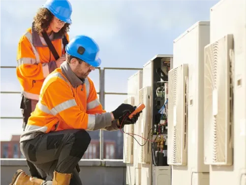 Maintenance workers performing a diagnostic check on commercial HVAC equipment.